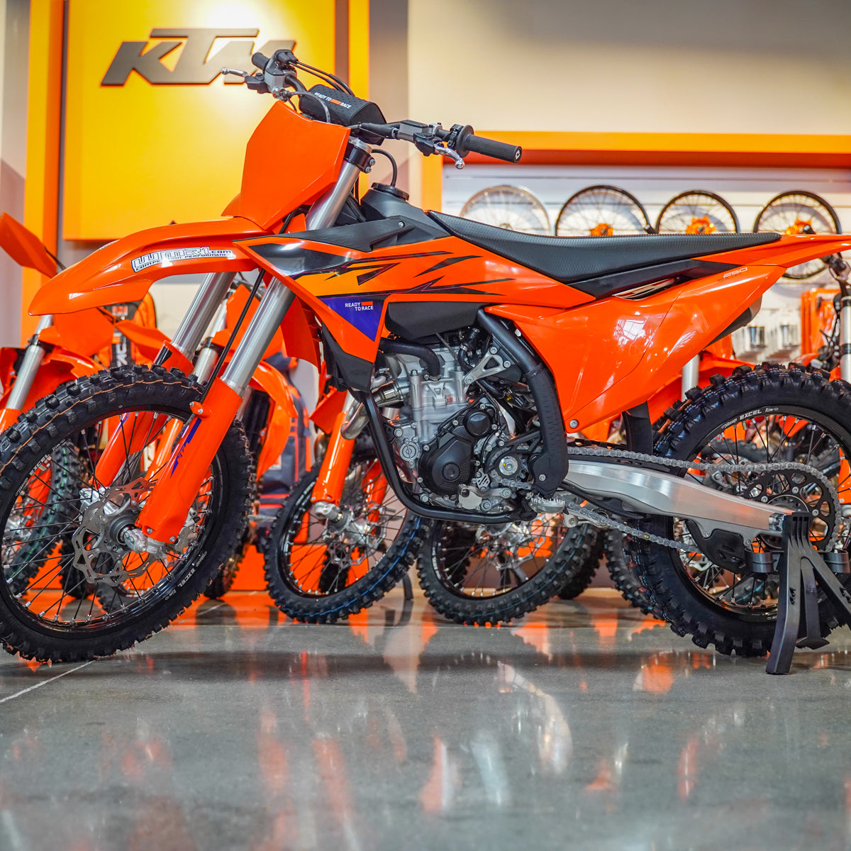 Orange KTM dirt bike on display in a showroom - best price around on KTM 250 SX-F