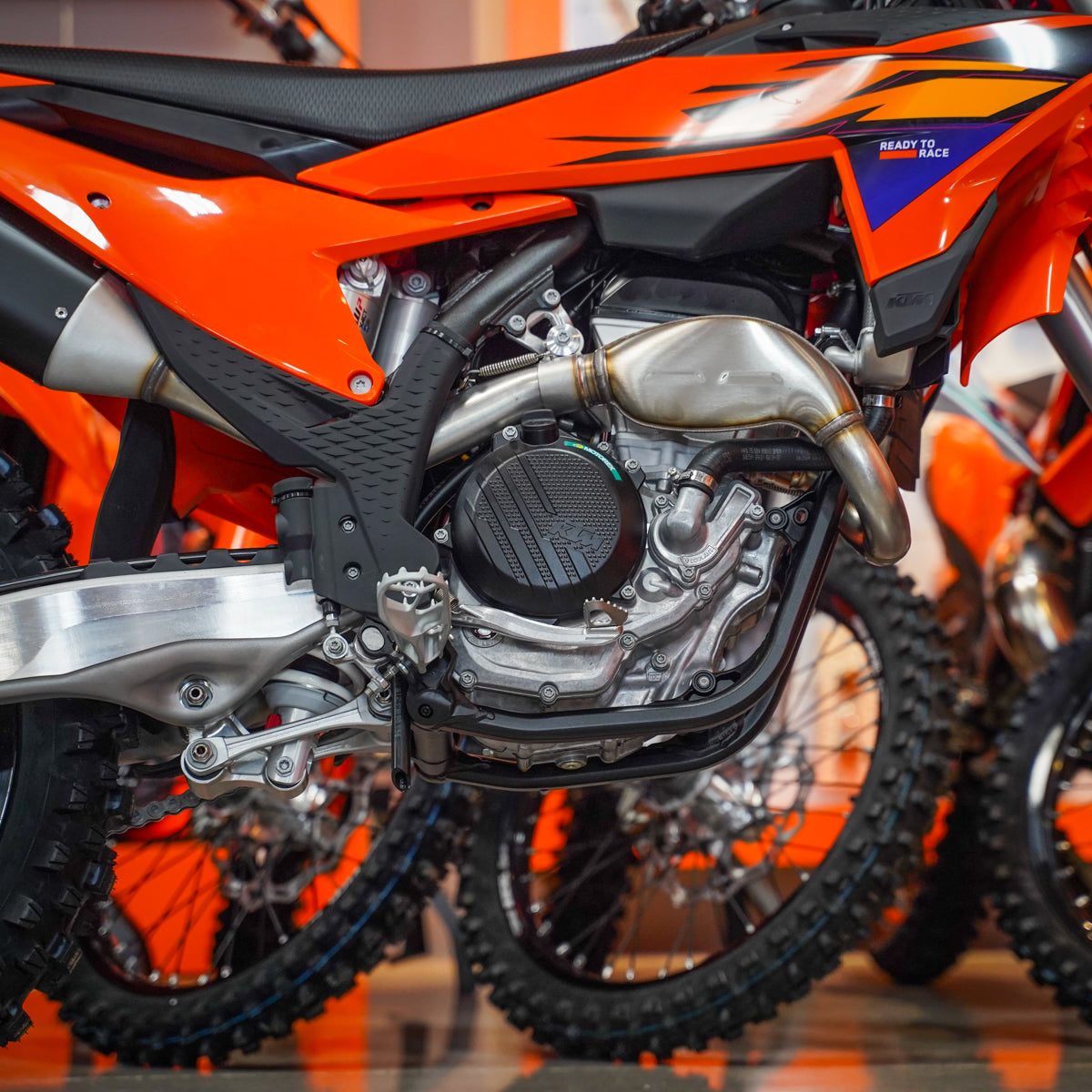 Close-up of an orange and black dirt bike engine - KTM 250 SX-F engine