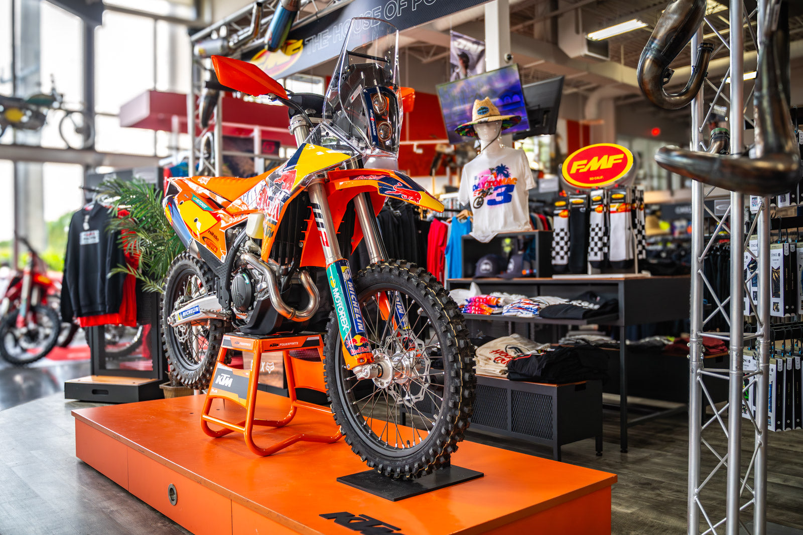 KTM 500 XW-F Rally Kit Motorcycle on display in a showroom with various items and branding visible.