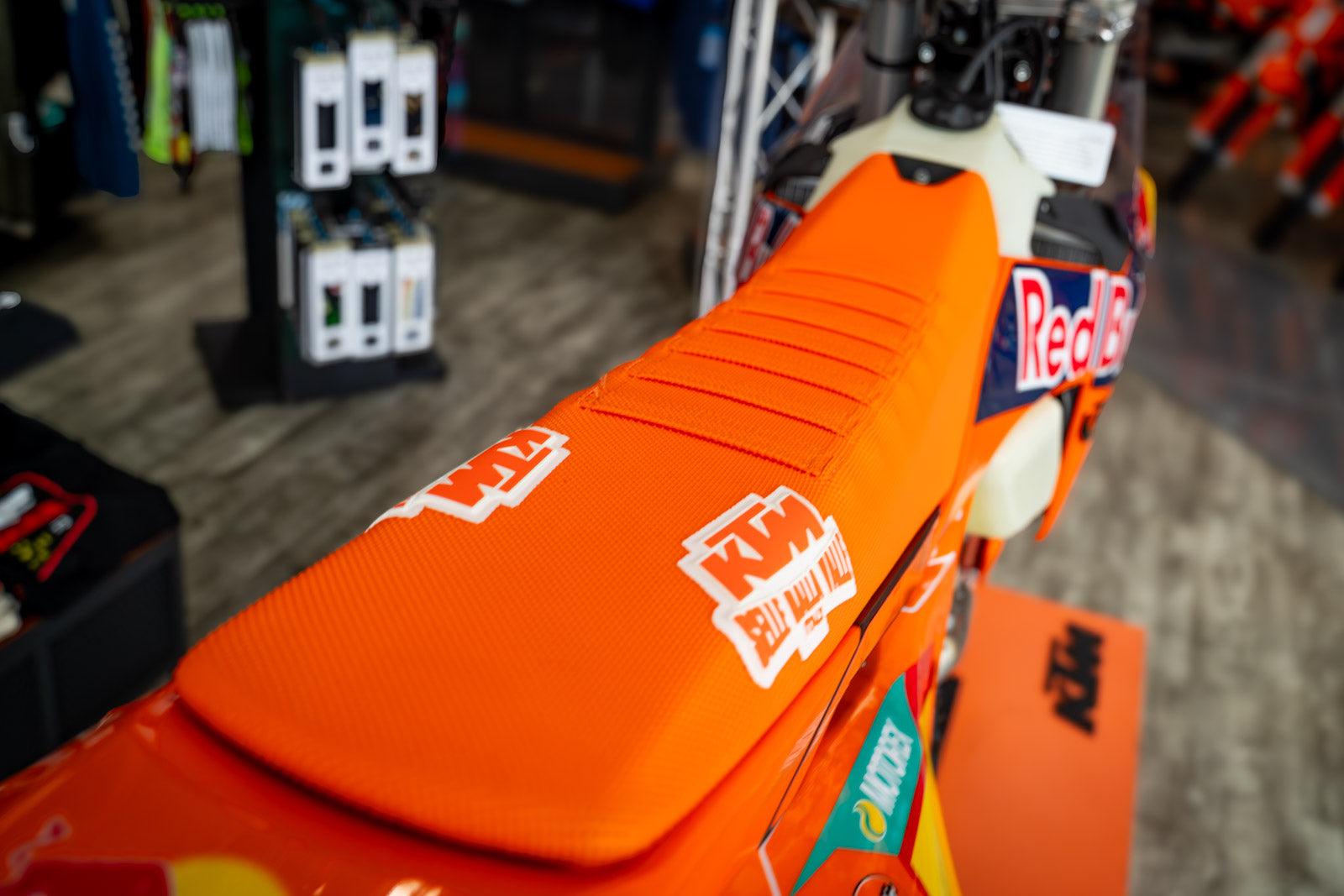Close-up of an orange motorcycle seat Selle Dalla valle with branding in a store setting