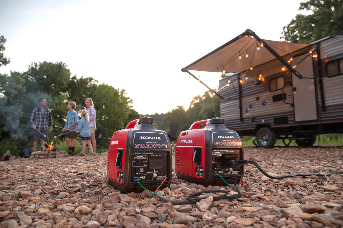 Honda EU2200i inverter generator powering an RV at a campsite