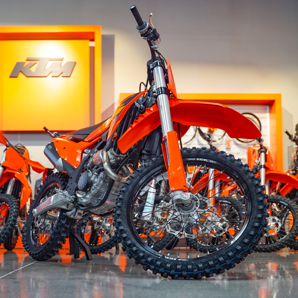Orange KTM dirt bike in a showroom setting KTM 250 SX-F Best Deal Front view